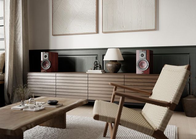 Pair of bookshelf speakers on a long console in a stylish living room