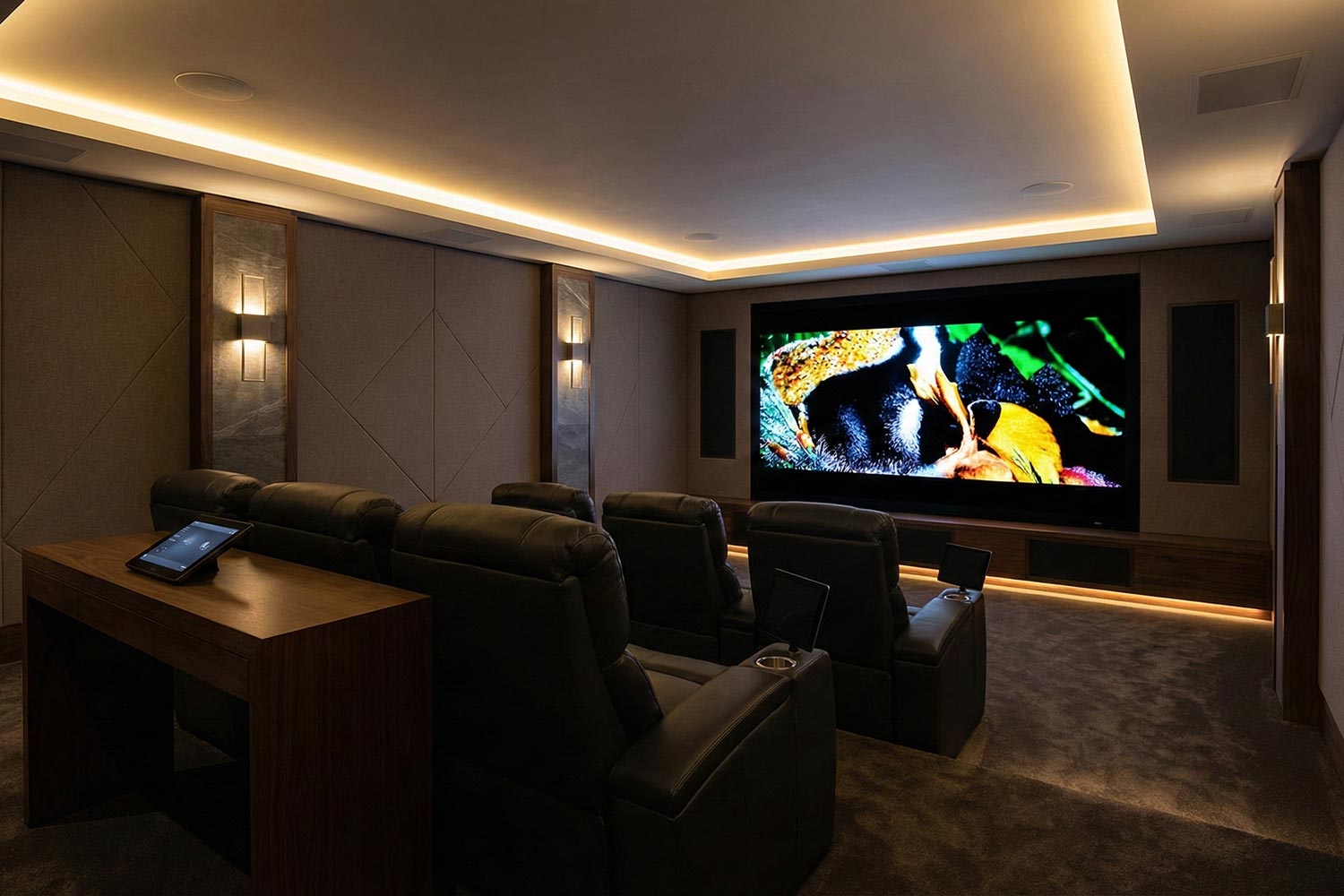 Modern media room with tiered leather recliners and ambient cove lighting