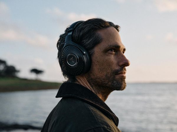 Man wearing black headphones by the water