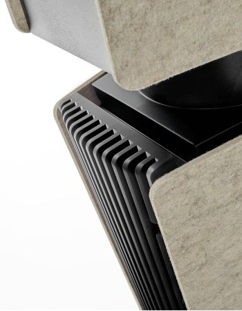 Close view of a speaker corner with black fins and light fabric panels