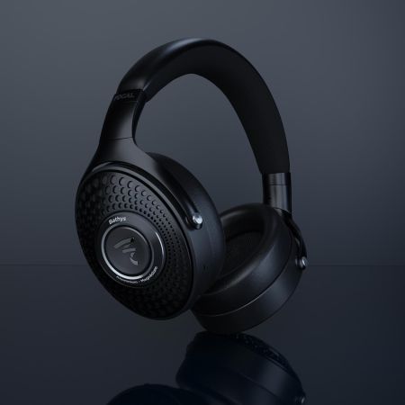 Black over-ear headphones with textured ear cups displayed against a dark background