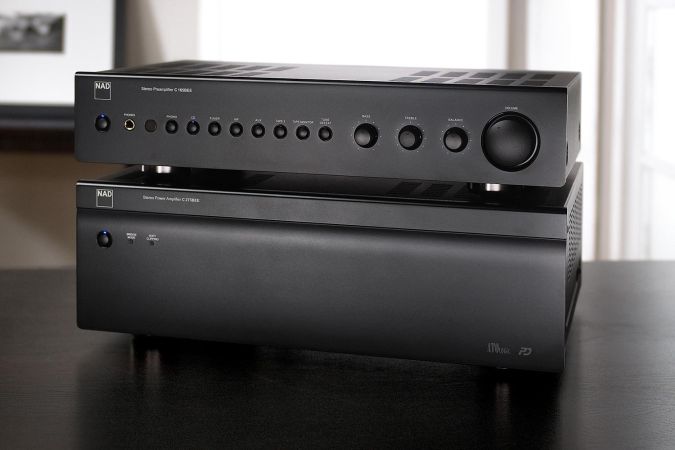 A stereo preamplifier and power amplifier stacked together on a black surface, designed with simplicity and precision in mind.