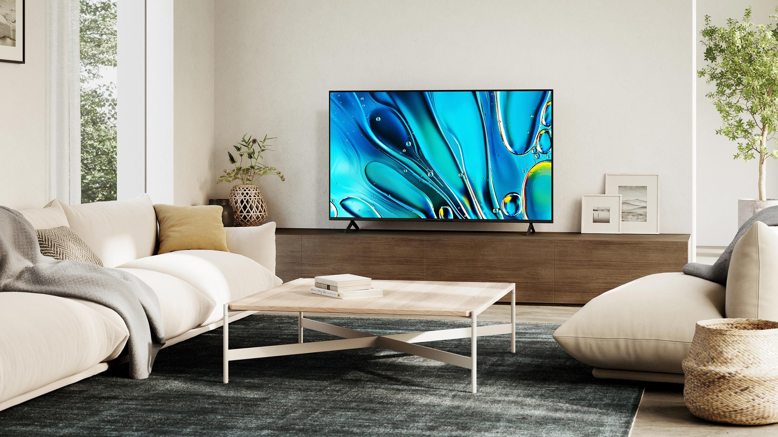 Contemporary media room with a large Sony Bravia TV displaying vibrant abstract art, a light-colored sofa, and modern decor.