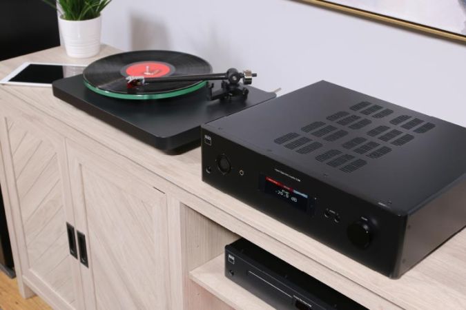 A stylish audio system with a record player and an amplifier on a wooden console, emphasizing clean lines and modern design.